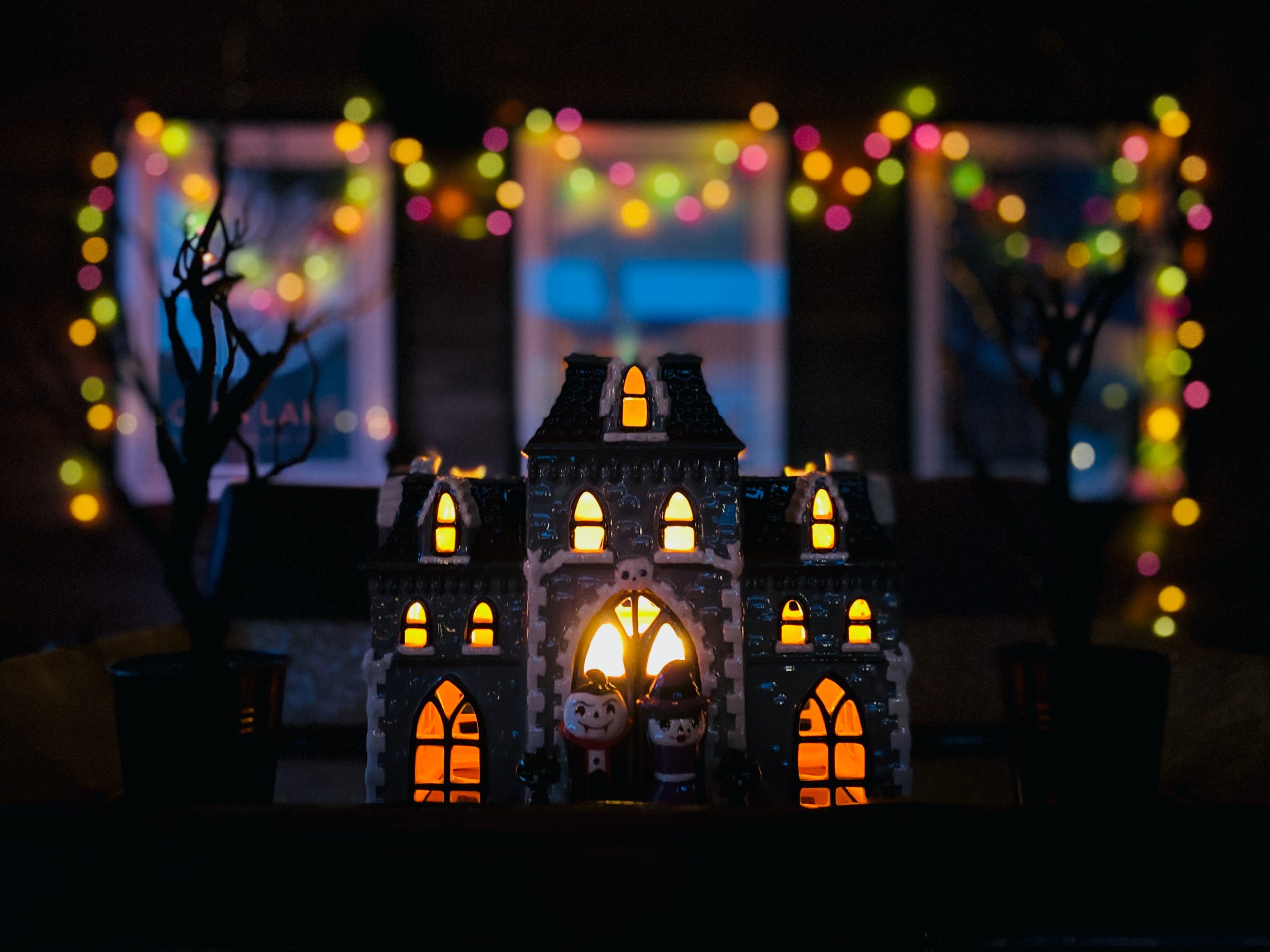 small dollhouse in the dark with lights